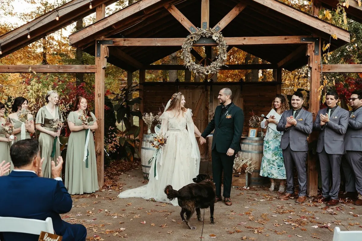 Autumn wedding couple celebrating with their dog