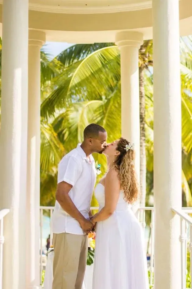Natalia Love Angelou with her husband under a tropical pavilion